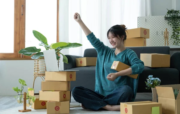 Portrait of Starting small businesses SME owners female entrepreneurs working on receipt box and check online orders to prepare to pack the boxes, sell to customers, SME business ideas online