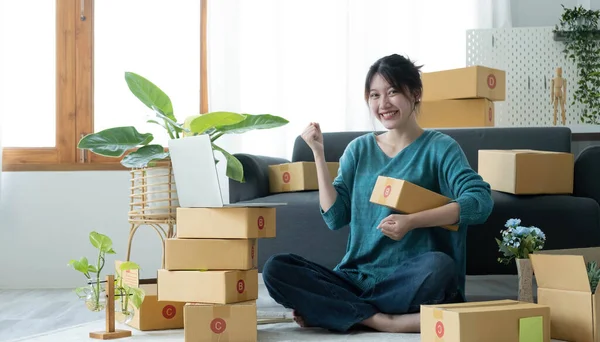 Portrait of Starting small businesses SME owners female entrepreneurs working on receipt box and check online orders to prepare to pack the boxes, sell to customers, SME business ideas online