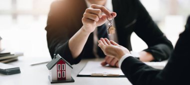 Agents or Dealer delivers keys is the new home to a customer, deal mortgage, making an agreement contract residence, real estate developer