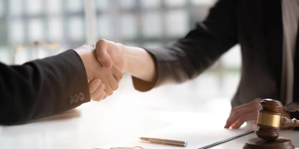 Businessman shaking hands partner lawyers or attorneys discussing a contract agreement