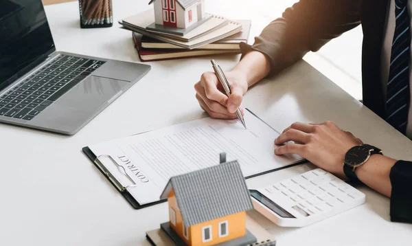 Business Signing a Contract Buy - sell house, Home for rent concept, broker agent presenting and consult detail to customer to making the decision a home estate loan to customer sign form agreement