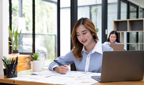 Portrait of smiling beautiful business asian woman working in office use computer with copy space. Business owner people sme freelance online marketing e-commerce telemarketing, work from home concep