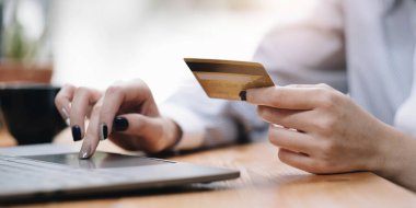 Hands holding credit card, typing on the keyboard of laptop, onine shopping detail close u