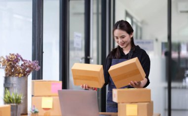 Startup small business SME, Entrepreneur owner checking online purchase shopping order to preparing pack product box. Selling online ideas concep