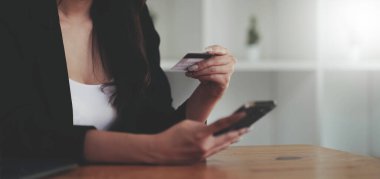 Woman hands holding smartphone shopping online with credit card. Online Payment. Online shopping concept