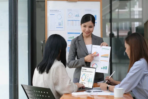 Asian woman lead group of young Asian business creative team in brainstorm meeting presentation. Girl power, colleague coworker partnership teamwork, people cooperation, or idea sharing concep