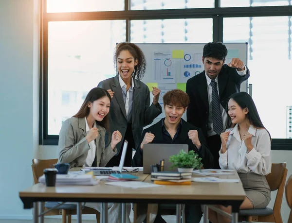 Young happy Asian business man, woman work together, celebrate success in start up office. Creative team brainstorm meeting, businesspeople colleague partnership or office coworker teamwork concep