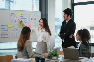 Kadın Operasyon Müdürü Ekonomistler Ekibi için Toplantı Sunumu Yapıyor. Asyalı Kadın Büyüme Analizi, Grafikleri, İstatistikleri ve Verileri ile Dijital Beyaztahta Kullanıyor. İnsanlar İş Ofisinde Çalışıyor