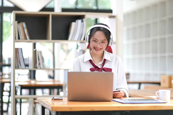 Asian girl student online learning class study online video call zoom teacher, Happy asian girl learn english language online with computer laptop