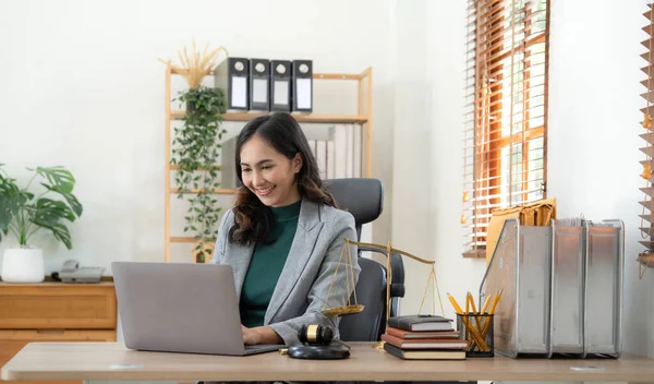 Asian business lawyer woman working with computer laptop in legal office.Law and Legal services concept..