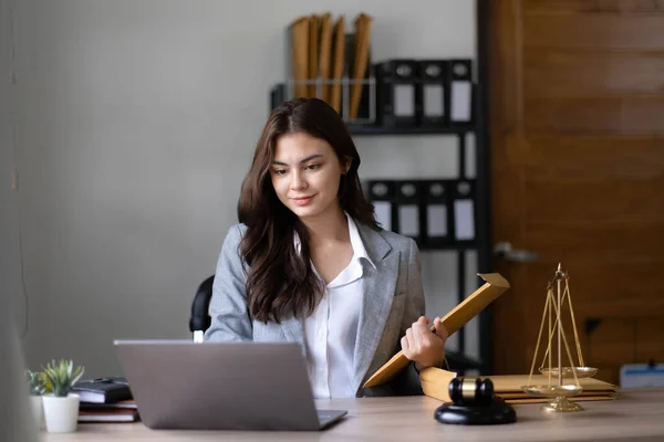Asian lawyer woman working with a laptop computer in a law office. Legal and legal service concept