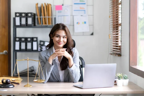 Asian lawyer woman working with a laptop computer in a law office. Legal and legal service concept