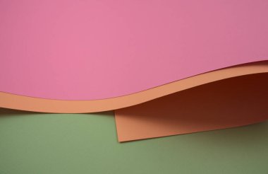 Elegant curved colors paper abstract. Pastel pink, old rose, and light green colorful papers. Horizontal, no people, high angle image style with free space.