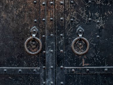 Eski manastır kapılarında kapı tokmağı var. Kapıyı çaldığı için metalle dövülmüş.