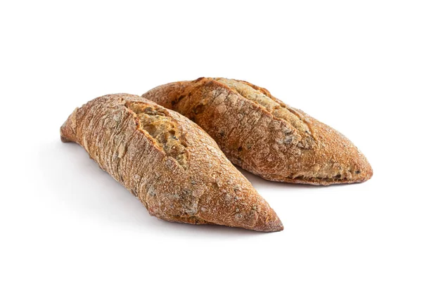 Çavdar unundan yapılmış iki tahıl çöreği keten tohumu ve susam tohumuyla, kızarmış kabukta bir kesik, beyaz bir arka planda izole edilmiş.