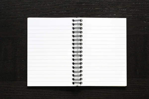Notebook on dark desk — Stock Photo, Image
