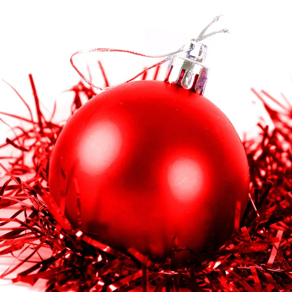 Red christmas ball with tinsel — Stock Photo, Image