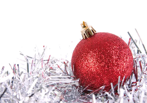 Red christmas ball with tinsel — Stock Photo, Image