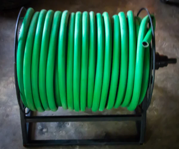 Watering garden hose on the spool — Stock Photo, Image