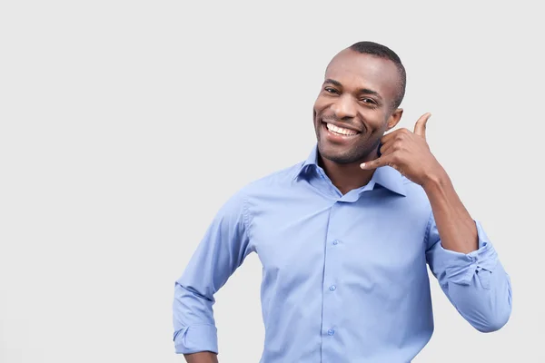 African man showing a call me sign and smiling — Stock Photo, Image