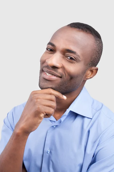 Tankfull ung man håller handen på hakan och leende — Stockfoto