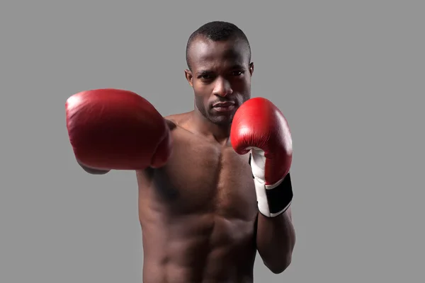 African boxer in boxing gloves stretching out his hand — Stock Photo, Image