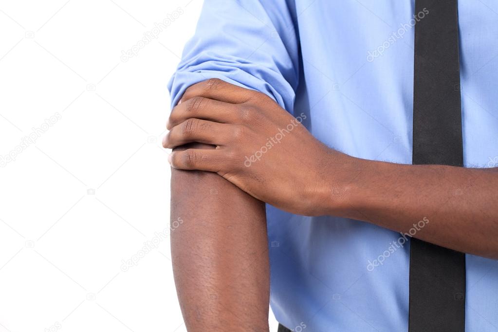 Black man in shirt and tie adjusting his sleeves