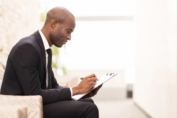 Businessman working on digital tablet and smiling — Stock Photo, Image