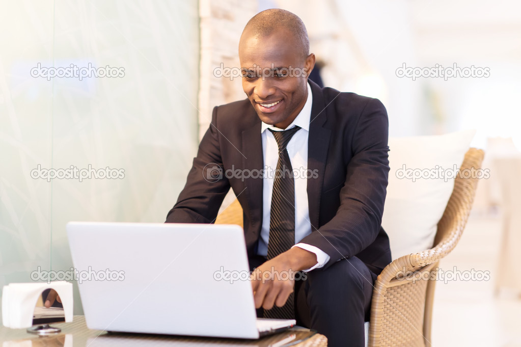 Businessman typing something on laptop