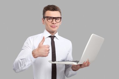 Dizüstü bilgisayar tutan adam.