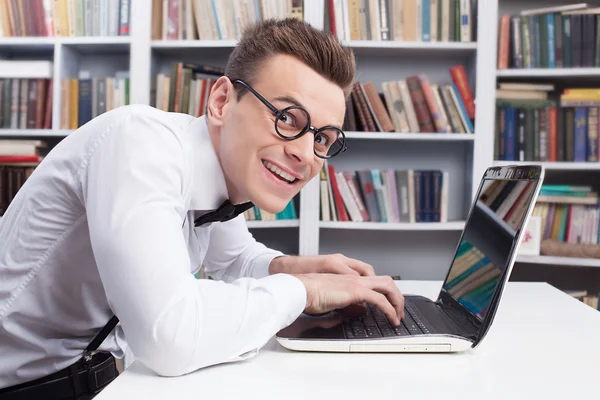 Nerd homem na camisa e laço gravata digitando algo no computador — Fotografia de Stock