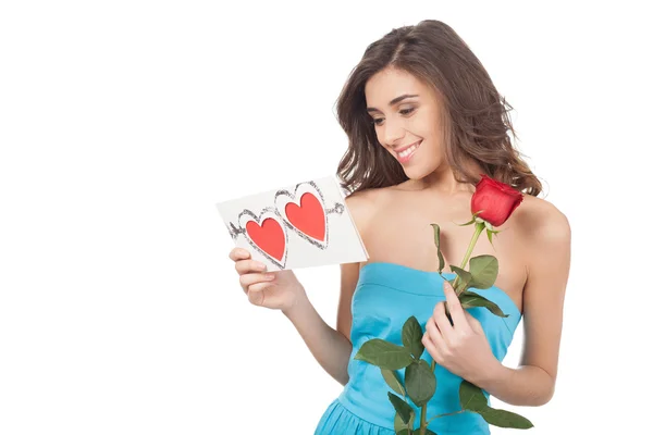 Beautiful young woman holding a red rose — Stock Photo, Image