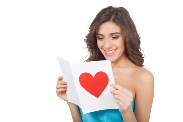 Attractive young woman reading a valentine card Royalty Free Stock Images