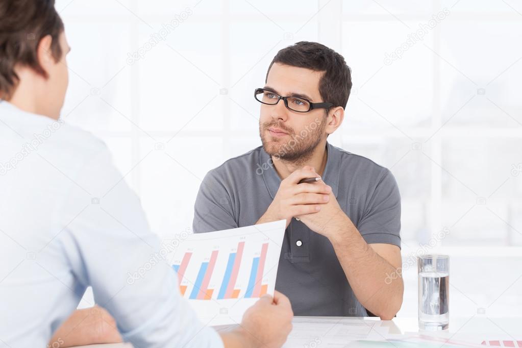 Two confident business people discussing something