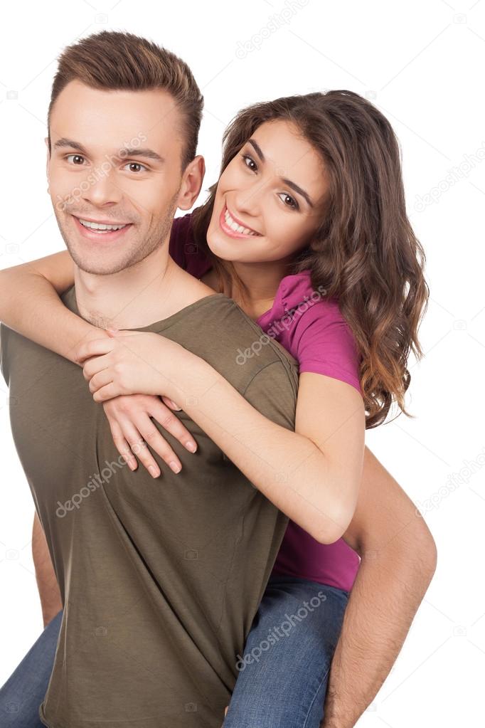 Cheerful young loving couple hugging