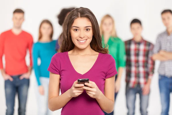 Cheerful young woman holding mobile phone — Stock Photo, Image