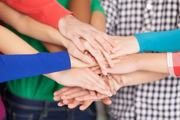 Many hands clasped together Stock Photo
