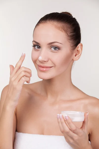 Young woman with cream on her nose — Stock Photo, Image