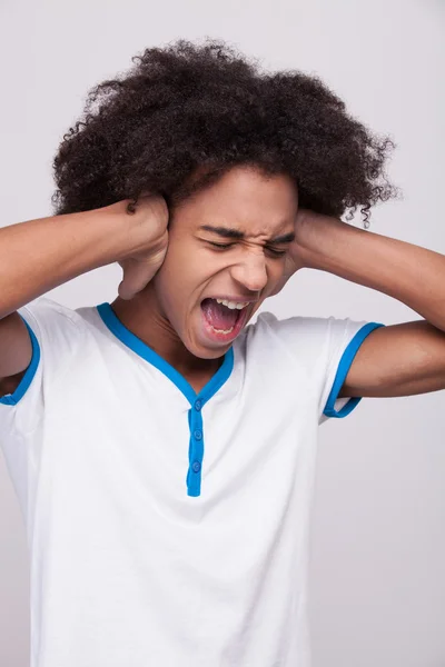 Adolescente africano gritando y cubriendo las orejas con las manos —  Fotos de Stock