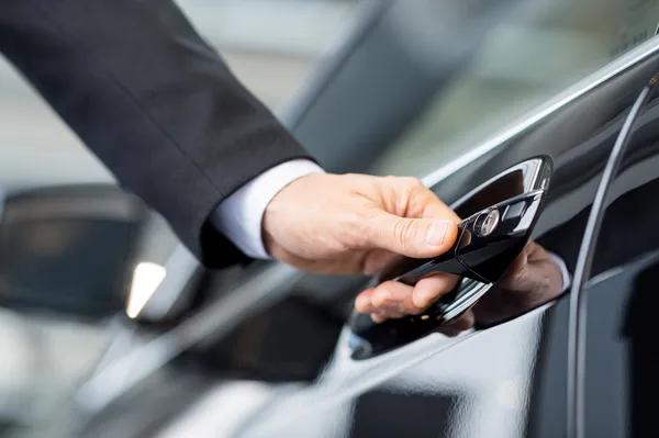 A abrir o carro novo. Close-up da mão masculina segurando a alça do carro — Fotografia de Stock