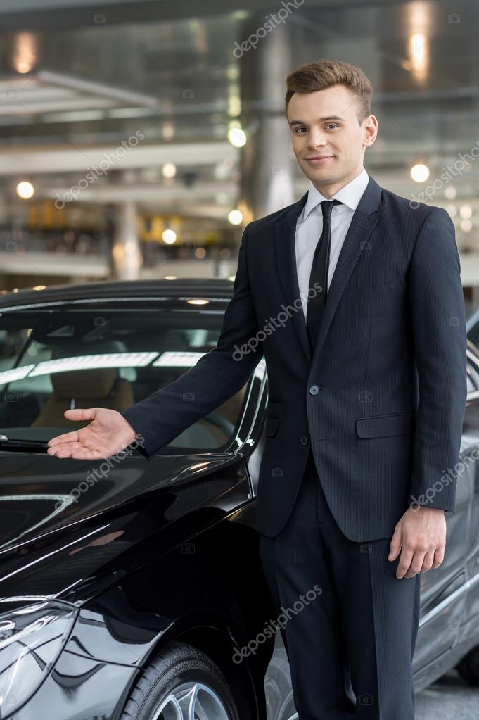 Handsome young car salesman Stock Photo by ©gstockstudio 39318775