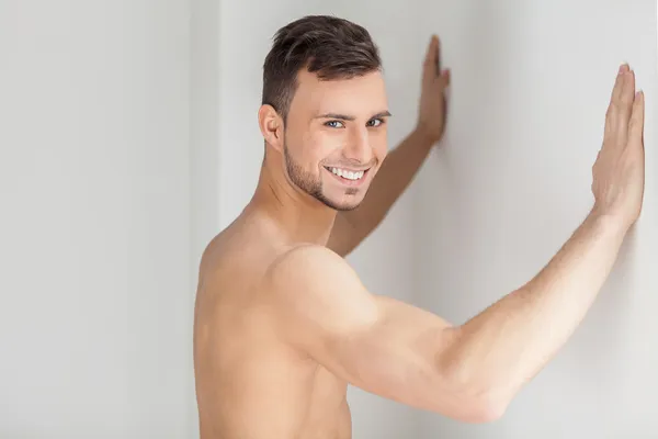 Muskularny mężczyzna oparty na ścianie — Zdjęcie stockowe