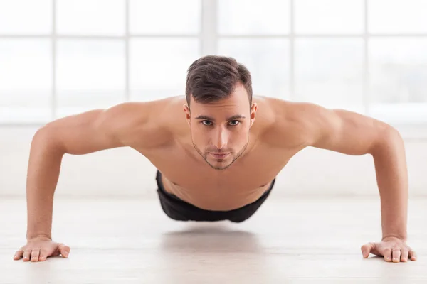 Muscular man doing push-ups — Stock Photo, Image