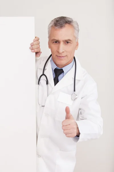 Doctor in uniform looking out of copy space — Stock Photo, Image