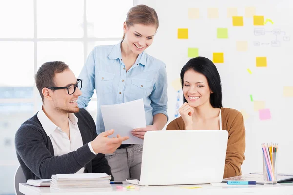 Three cheerful young colleagues — Stock Photo, Image