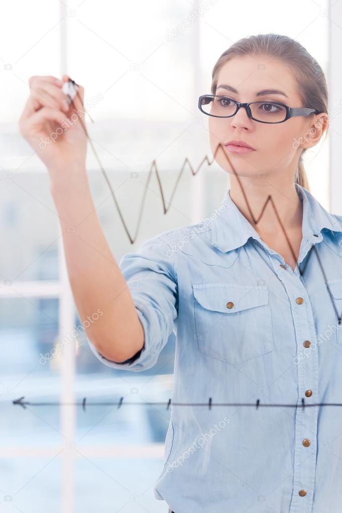Businesswoman drawing a graph.