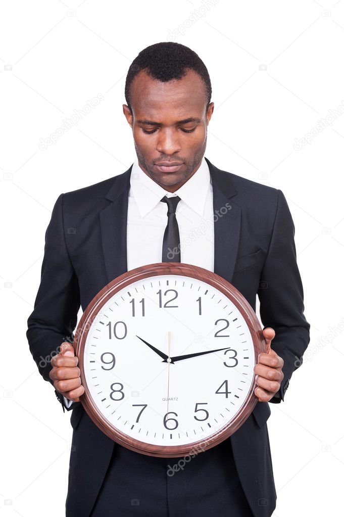 African man holding clock