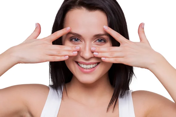 Woman holding hands near eyes and smiling — Stock Photo, Image