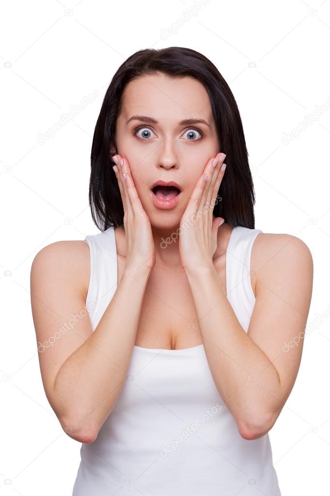 Woman holding head in hands and keeping mouth open