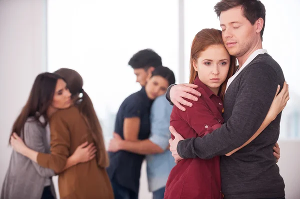 Group of depressed people hugging each other — Stock Photo, Image